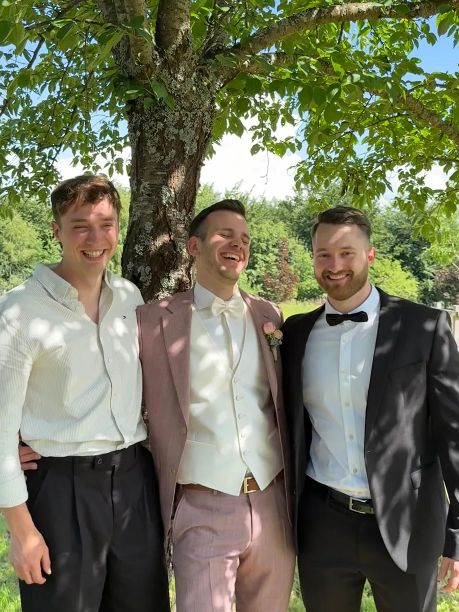 From left: Benedict Mehlmann, Joshua Schätzle and Marcel Reinbold, laughing under a tree